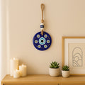 Close-up of blue Evil Eye Wall Hanging charm with beads and natural jute rope