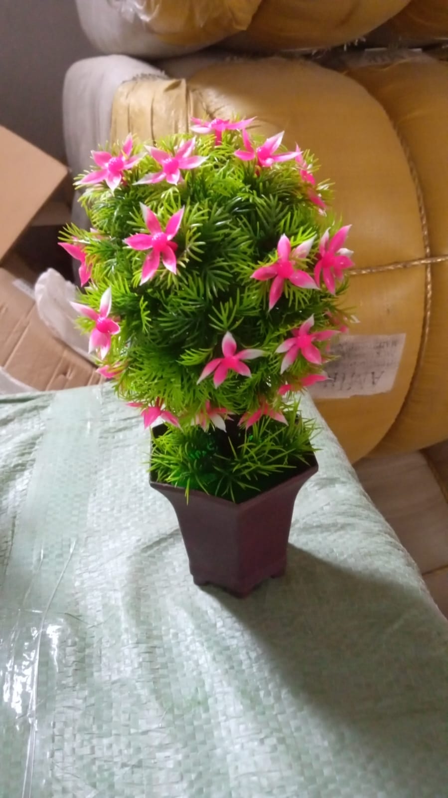 Rear view of the artificial plant showcasing its full form and cute pot.